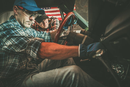 American Classic Car Owner and His Professional Car Mechanic Performing Checksの写真素材