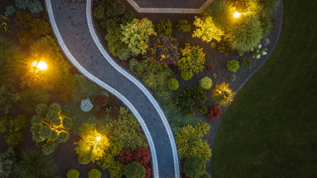 Elegant Residential Back Yard Garden Illuminated by Outdoor LED Lighting. Aerial view.