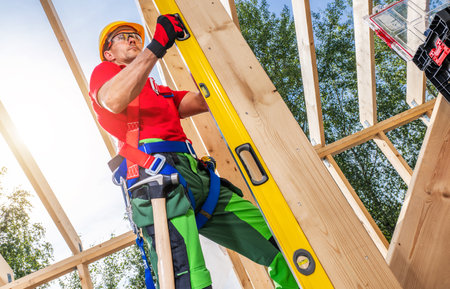 Caucasian Skeleton Frame Worker with Large Spirit Level Accuracy. Construction Industry Theme.