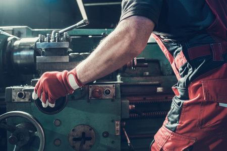 Caucasian Metalworking Worker in His 40s Operating Lathe Machine. Industrial Theme.の写真素材
