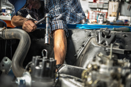 Caucasian Professional Car Mechanic Repairs Gasoline Engine in His Clients Carの写真素材