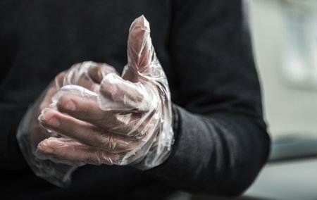 Caucasian Man Wearing Vinyl One Time Use Gloves For Bacteria and Viruses Protectionの写真素材