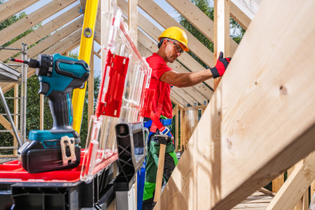 Caucasian Contractor Assembling Wooden Building Structure. Tool Boxes and Power Tools.の写真素材