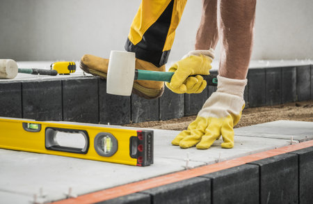 Concrete Bricks Patio Building by Professional Caucasian Construction Worker