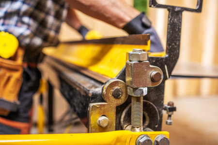 Industrial Sheet Metal Bending Performing by Caucasian Construction Contractorの写真素材