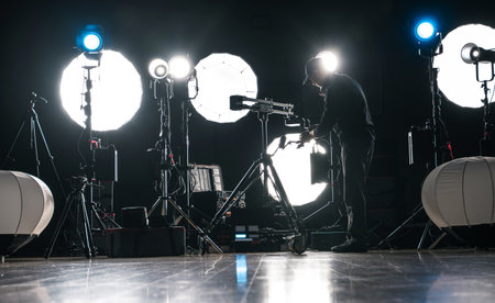 A Man Assembling Powerful Modern LED Video and Photo Lighting Inside Dark Production Studioの写真素材