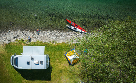 Scenic Summer Camper Van RV Riverside Camping with Kayaksの写真素材
