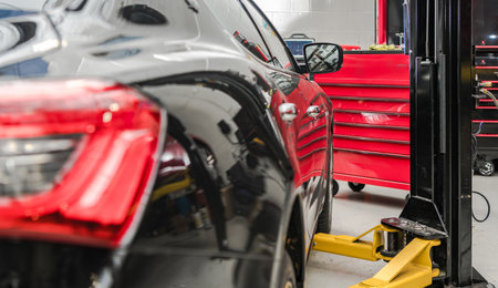 Modern Vehicle Under Maintenance Inside Dealership Service Centerの写真素材