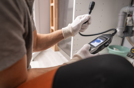 Caucasian Technician with Gas Detector in His Hands Checking For Potential Leaks