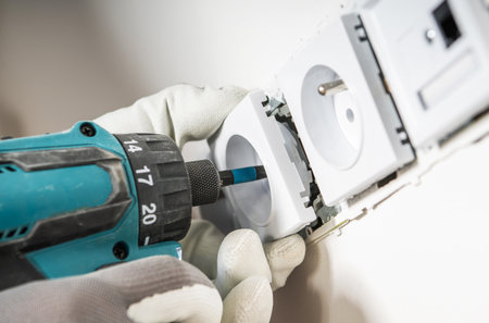 Electrician Installing Another Wall Mounted Power Outlet Close Up Photo