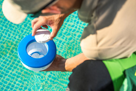 Homeowner Preparing Swimming Pool Chemical Dispenser