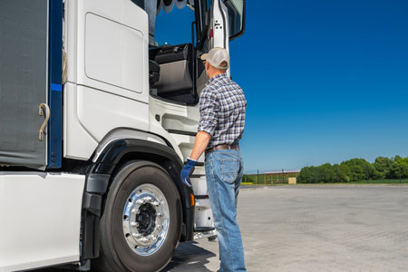 Caucasian Semi Truck Driver in His 40s Preparing to Work. Transportation Industry Theme.の写真素材
