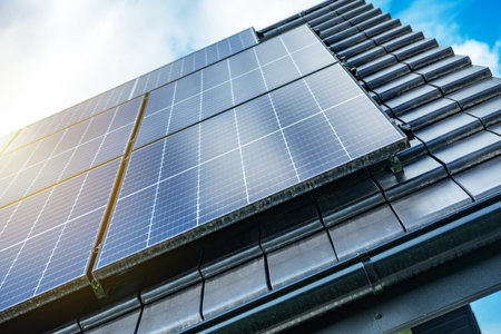 Solar panels are mounted on the roof of a contemporary building, efficiently capturing sunlight...