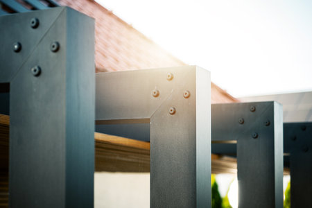 Metal framework showcases its intricately designed and craftsmanship under bright sunlight in an outdoor environment. The sleek lines and fasteners highlight the quality of construction.の写真素材