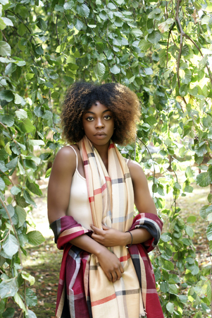Young Black Woman Autumn Sunshine in the Parkの写真素材