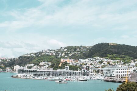 Photograph of the Wellington Waterfront as a boat leaves the dock on a sunny day