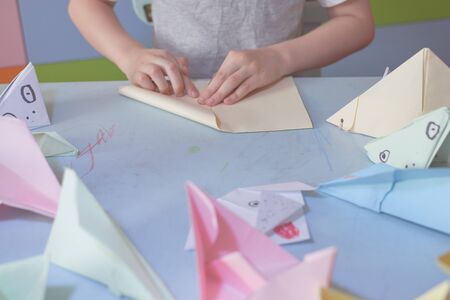 6 years boy makes an origami planes and frogs during quarantine Covid-19, self-isolation, online...