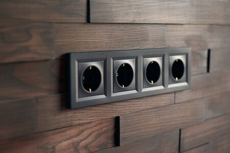 Electrical household switches and sockets close up. Minimalist interior design. Stylish bedroom and...