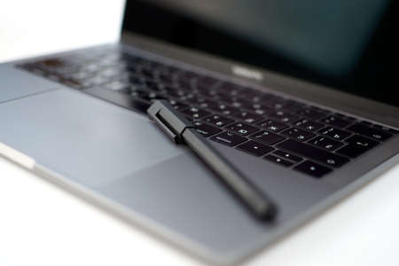 Close-up computer laptop keyboard, pen and pencilの写真素材