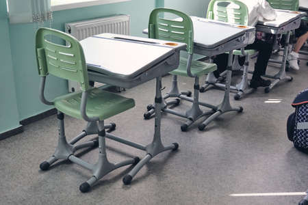 Moderd school smart classroom. View of elementary class room no kid or teacher with chairs and deskd...
