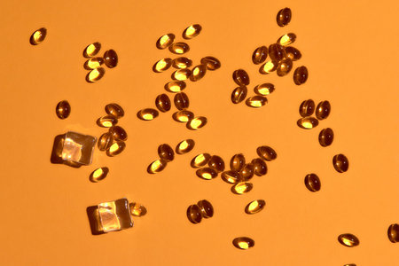 Many transparent pills Omega 3 or fish oil on a colorful background. Health supplements and...