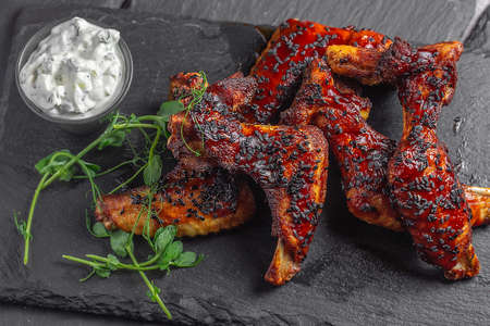 Plate of delicious Hot and spicy barbecue chicken wings. Grilled BBQ Juicey Chickenの写真素材