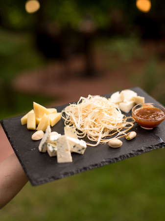 Assorted beer snacks, fast food. Cheese appetizer, cured meats with mug of beer.の写真素材