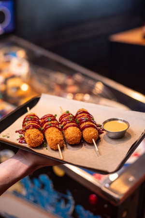 Assorted beer snacks, fast food. Fried Cheese Sticks, cured meats, nuggets with mug of beer.