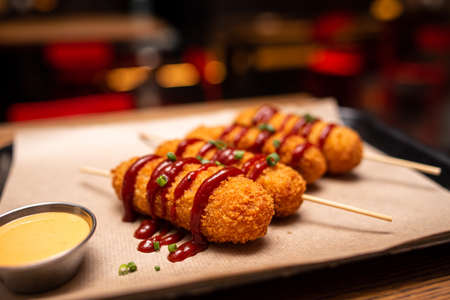 Assorted beer snacks, fast food. Fried Cheese Sticks, cured meats, nuggets with mug of beer.の写真素材