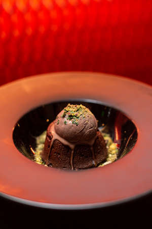 Delicious cake for desert in restaurant on a wooden table, no people are visible. Tasty chocolate...