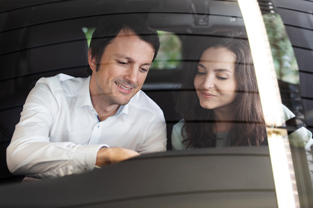 Car salesman shows a customer a carの写真素材
