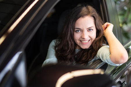 Young woman laughing happily in a carの写真素材