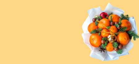 Christmas new year bouquet of oranges and tangerines, macadamia, spruce branchesの写真素材