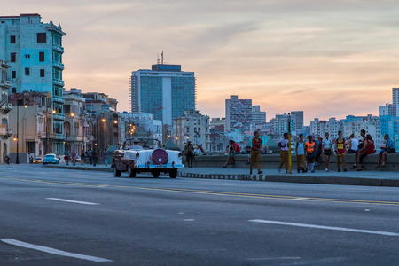 Top down on the old timer as it roars down the Malecon highway in Havana at dusk.のeditorial素材