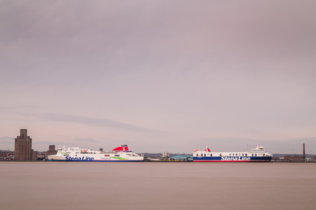 A pair of car ferries from Stenalina seen back to back moored on the Wirral side of the River Mersey.のeditorial素材