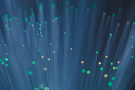 Green lights begin to turn to amber on a colour changing fibre optic lamp captured up close.の写真素材