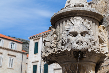Water flowing out of the one of the faces on the Amerling fountain in Gundulic Square, Dubrovnik.の写真素材