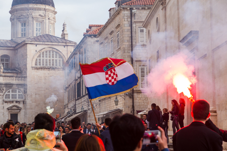 Flares are lit and the Croatian flag is waved as a wedding congregation passes through Dubrovnik's old town.のeditorial素材