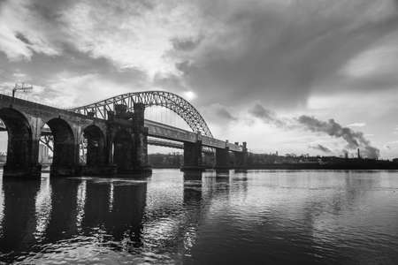 The Runcorn Railway Bridge  (foreground) and the Silver Jubilee Bridge (background) captured in black and white in December 2020.の写真素材