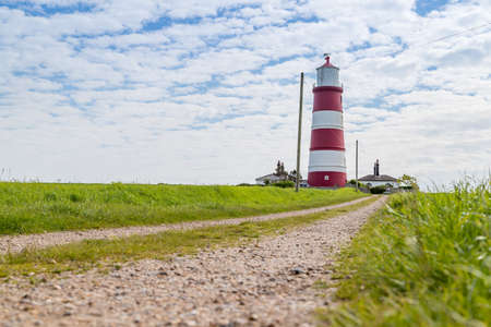 A pathway leads up to Happisburgh lighthouse,  the oldest working lighthouse in East Anglia seen in June 2021.の写真素材