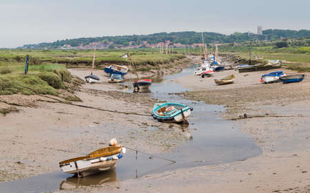 Small boats seen down a channel at Blakeney on the North Norfolk coast in June 2021.のeditorial素材