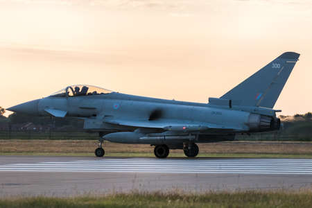 RAF Typhoon prepares to take off at sunset from RAF Coningsby in Lincolnshire during the summer of...