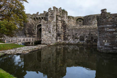 Beaumaris Castle reflecting in its moat during October 2021 seen on the North Wales coast.のeditorial素材
