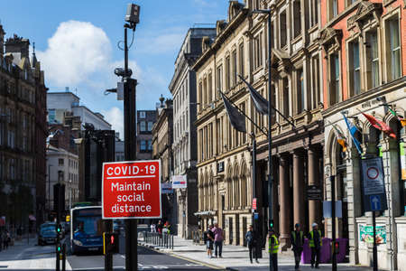 A red road sign reminding people to maintain social distance seen in Liverpool, England in September 2020 during the Covid19 pandemic.のeditorial素材