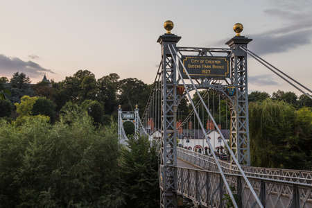 Queens Park suspension bridge seen over the River Dee in Chester in September 2021.のeditorial素材