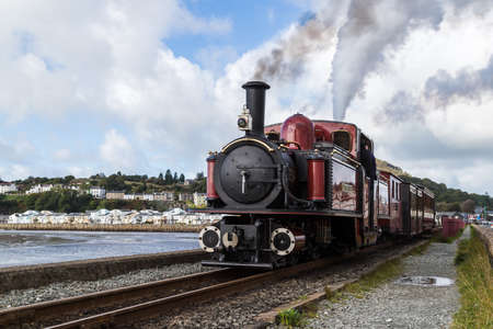 FR Double Fairlie steam train pictured chugging away down the Ffestiniog over The Cob at Porthmadog in North Wales during October 2021.のeditorial素材
