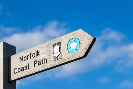 Norfolk coastal path sign captured against a blue sky in the summer of 2021 at Wells next the Sea on the North Norfolk coast.のeditorial素材