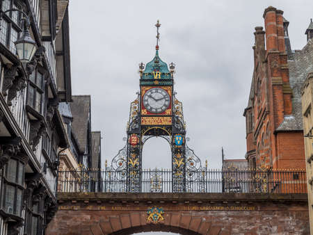 Eastgate Clock on the Chester skyline seen between some old buildings in September 2021.のeditorial素材