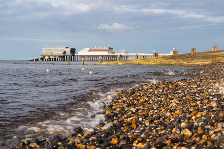Gulls bob on the waves at Cromer in front of iconic Victorian pier during the summer of 2021.のeditorial素材