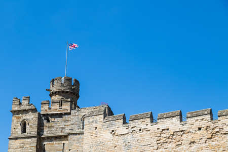 Union Jack above Lincoln castle seen in June 2021 under a blue sky.のeditorial素材
